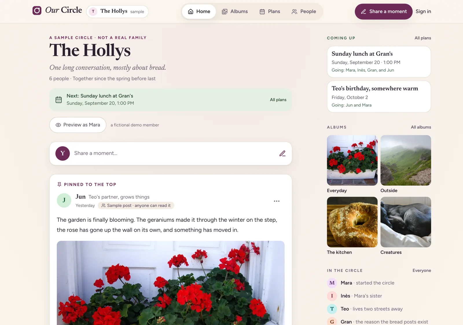 The Our Circle feed: a heading reading The Hollys above the line One long conversation, mostly about bread, a box to share a moment, and a pinned post from Jun about the garden with a photograph of red geraniums. A panel on the right lists what is coming up, four albums, and the people in the circle.